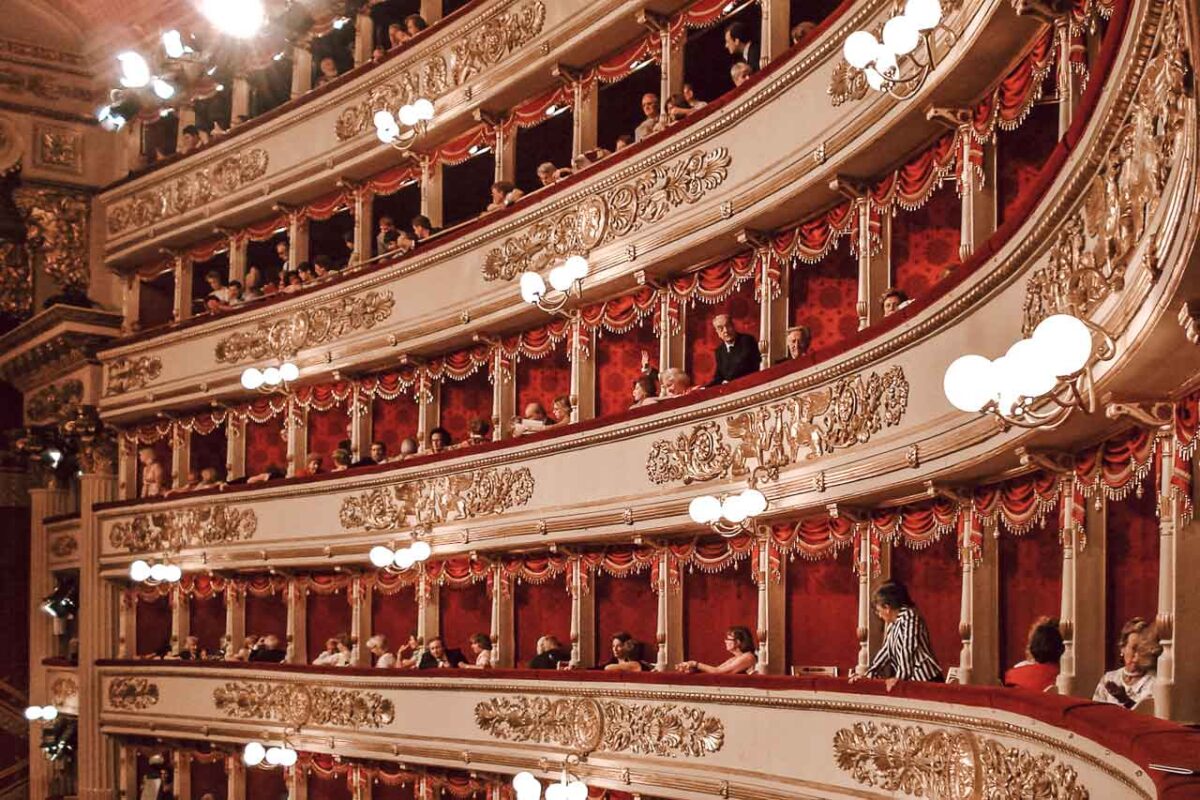 The interior of Milan's La Scala Theater, known for its elegant décor, richly decorated boxes and the atmosphere of a classic opera theater.