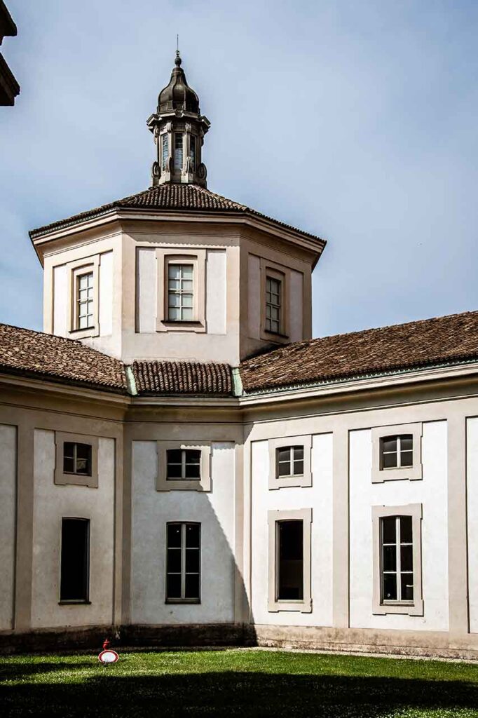A person feeding pigeons in the Piazza Duomo in Milan
