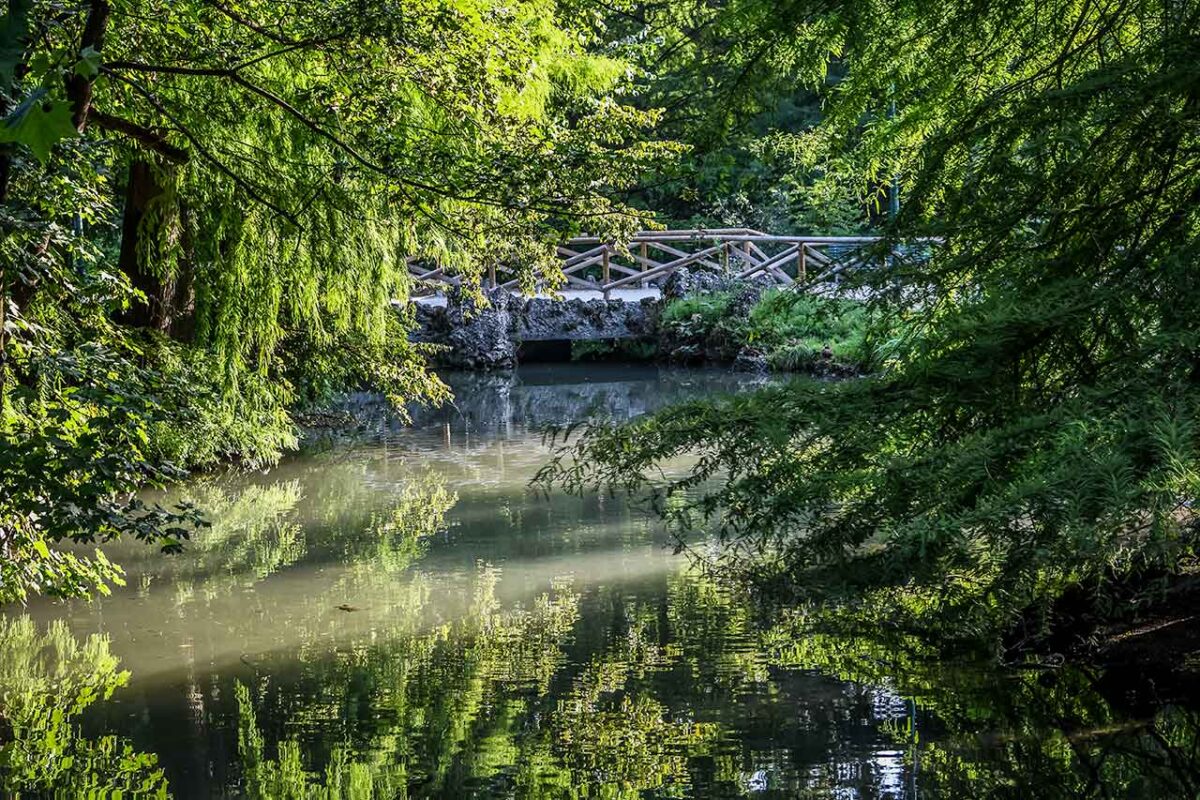 Picturesque greenery and a lake in Milan's Sempione Park, the perfect place to relax and get in touch with nature.