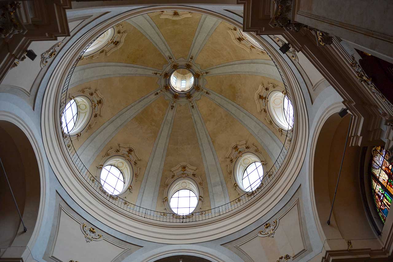 The interior of the dome of the Church of San Bernardino alle Ossa, decorated with Baroque frescoes, over an ossuary full of symbolism and history.