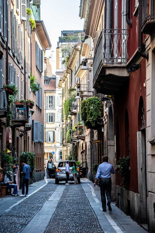 A narrow cobbled street in Brera with tenement houses and balconies 
